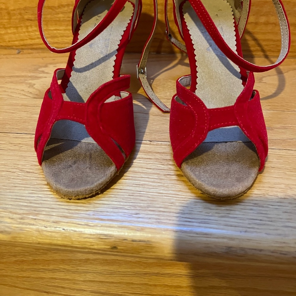 Red dancing shoes with ankle straps.